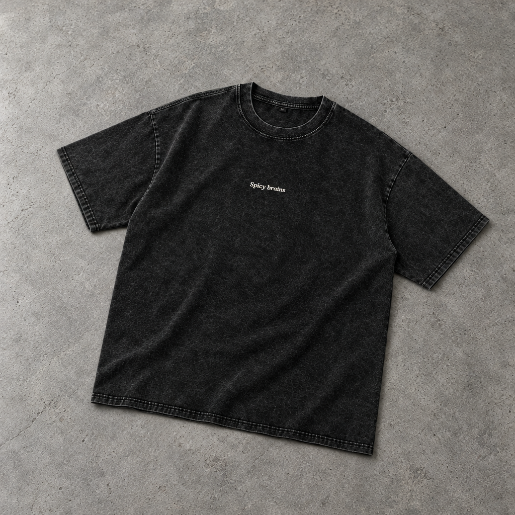 Stay Weird Spicy Brains oversized tee – washed black tee with small Spicy Brains chest print, flat lay, AI-generated mockup