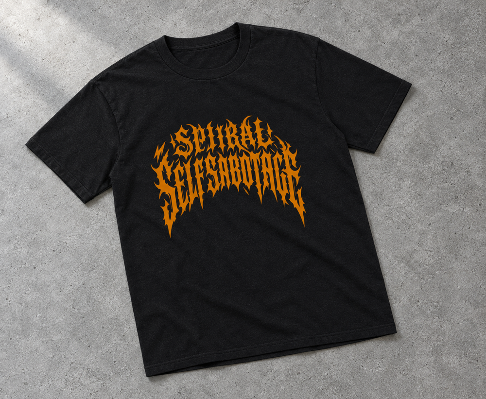 Spiral Self Sabotage oversized tee – black tee with burnt-orange Spiral Self Sabotage lettering, flat lay, AI-generated mockup