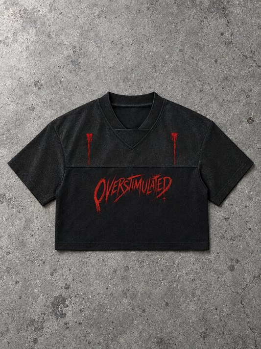 Overstimulated cropped V-neck jersey – black cropped jersey with red dripping Overstimulated print, flat lay, AI-generated mockup