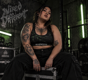 Wired Different sports bra – woman wearing the sports bra in a gym, seated, AI-generated mockup