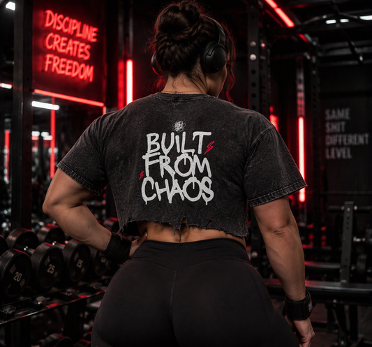 Built From Chaos boxy distressed tee – woman showing the Built From Chaos back print in a red neon gym, AI-generated mockup