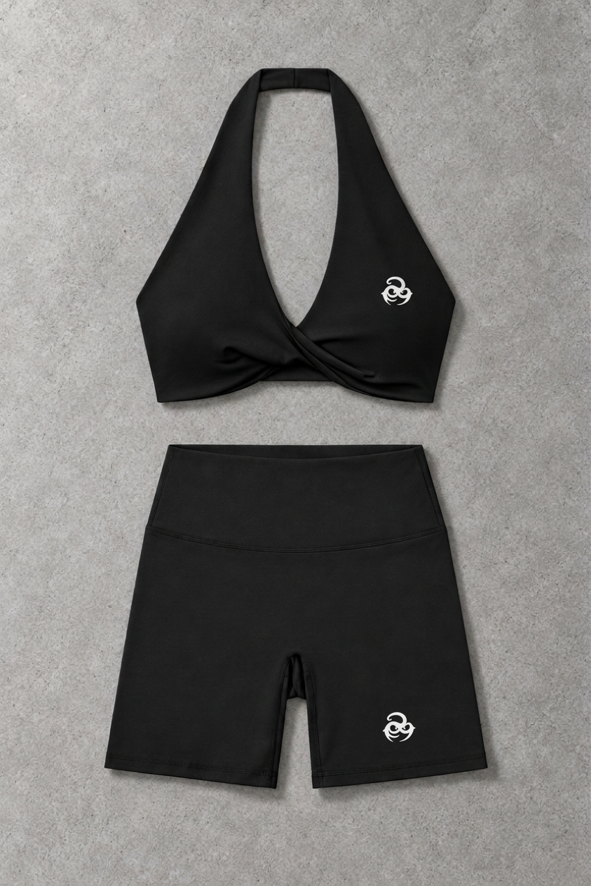 Oddens Core matching set – black twist halter sports bra and high-waisted biker shorts, flat lay, AI-generated mockup