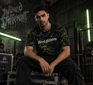 Wired Different men's oversized tee – man wearing the tee, seated, AI-generated mockup