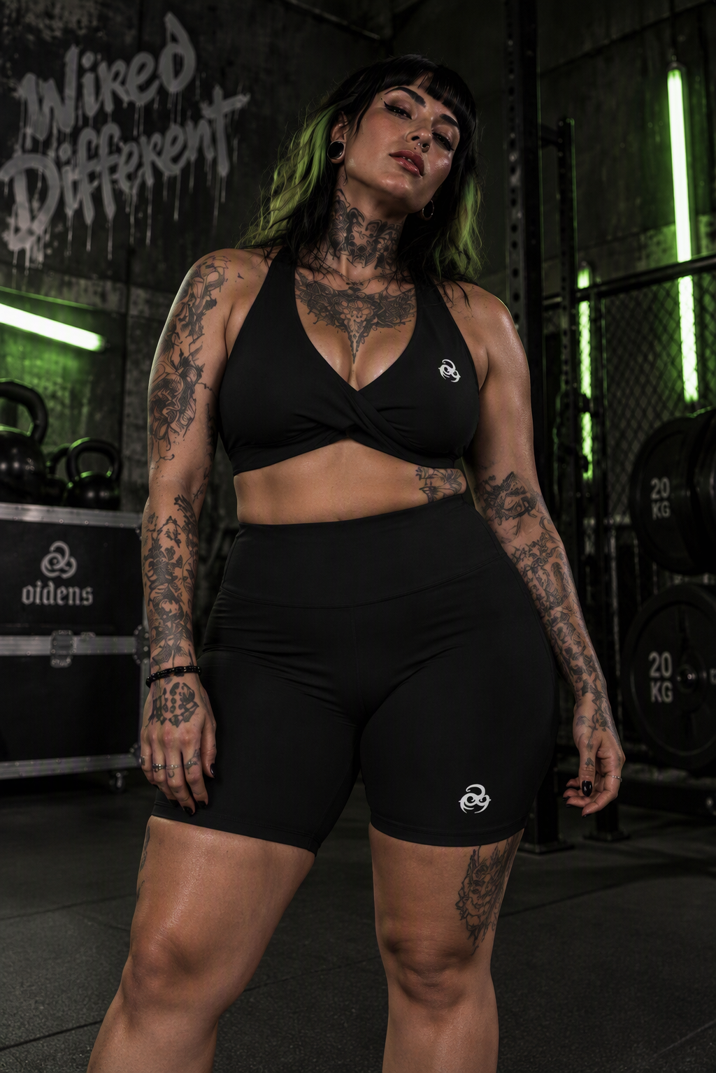 Oddens Core matching set – woman wearing the black halter sports bra and shorts in a gym, AI-generated mockup