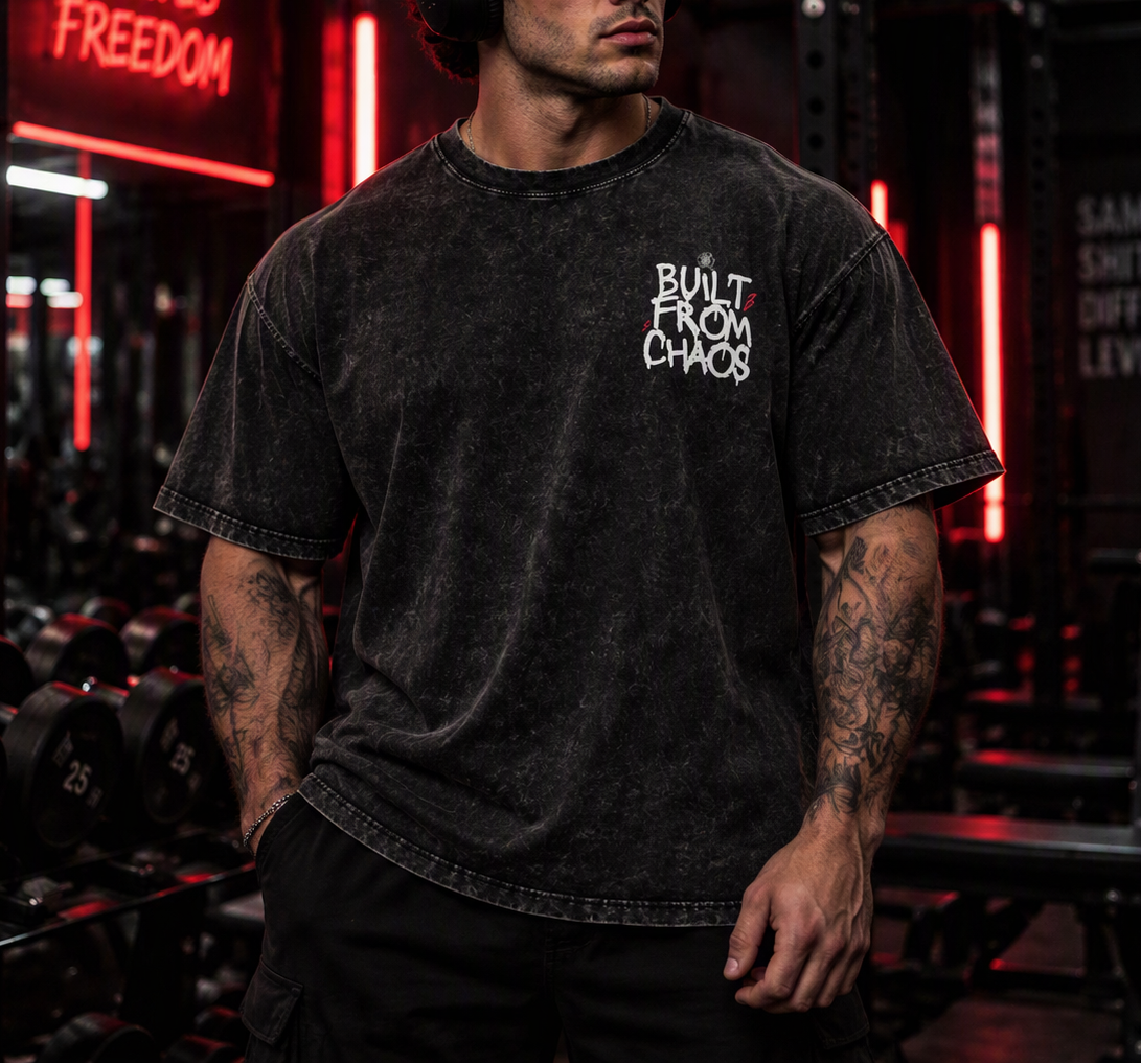 Built From Chaos oversized tee – man wearing the tee in a gym, front view, AI-generated mockup